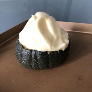 Gently spoon or pile the soufflé batter on top of the pumpkin puree in the shell. It should mound up nicely.