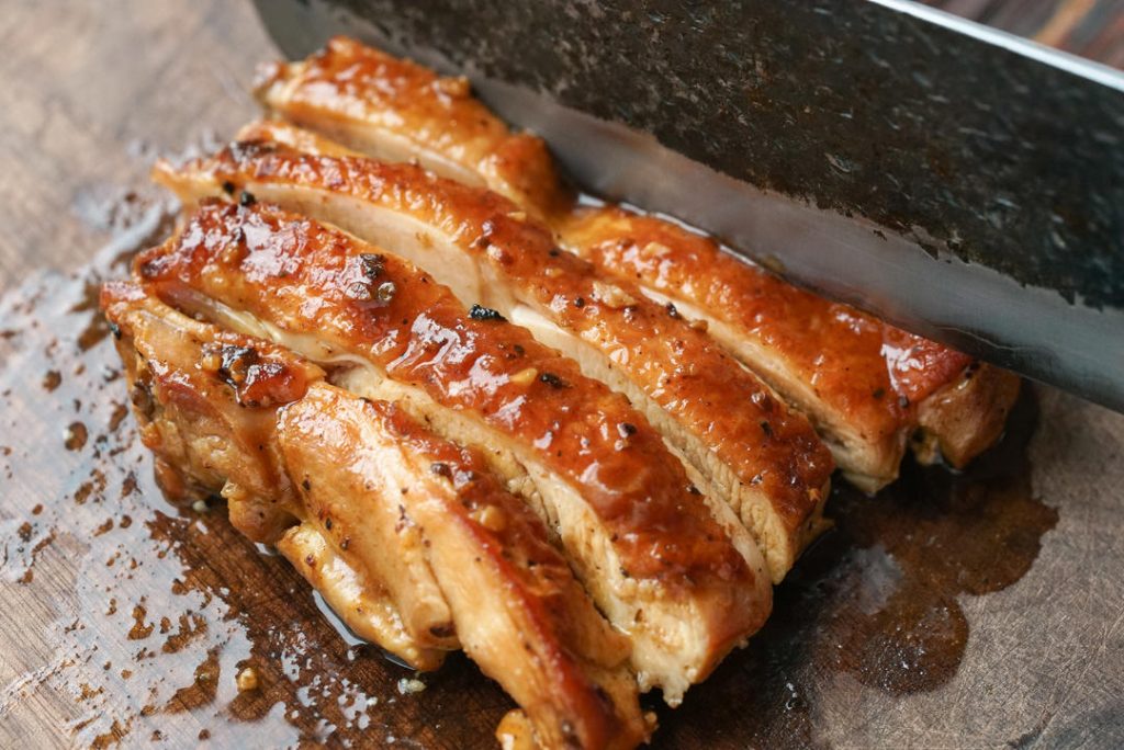 Remove the chicken and slice it into strips about 0.5 inches thick