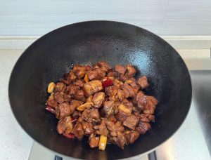 Add the salt, dark soy sauce, light soy sauce, oyster sauce, and the remaining cooking wine.