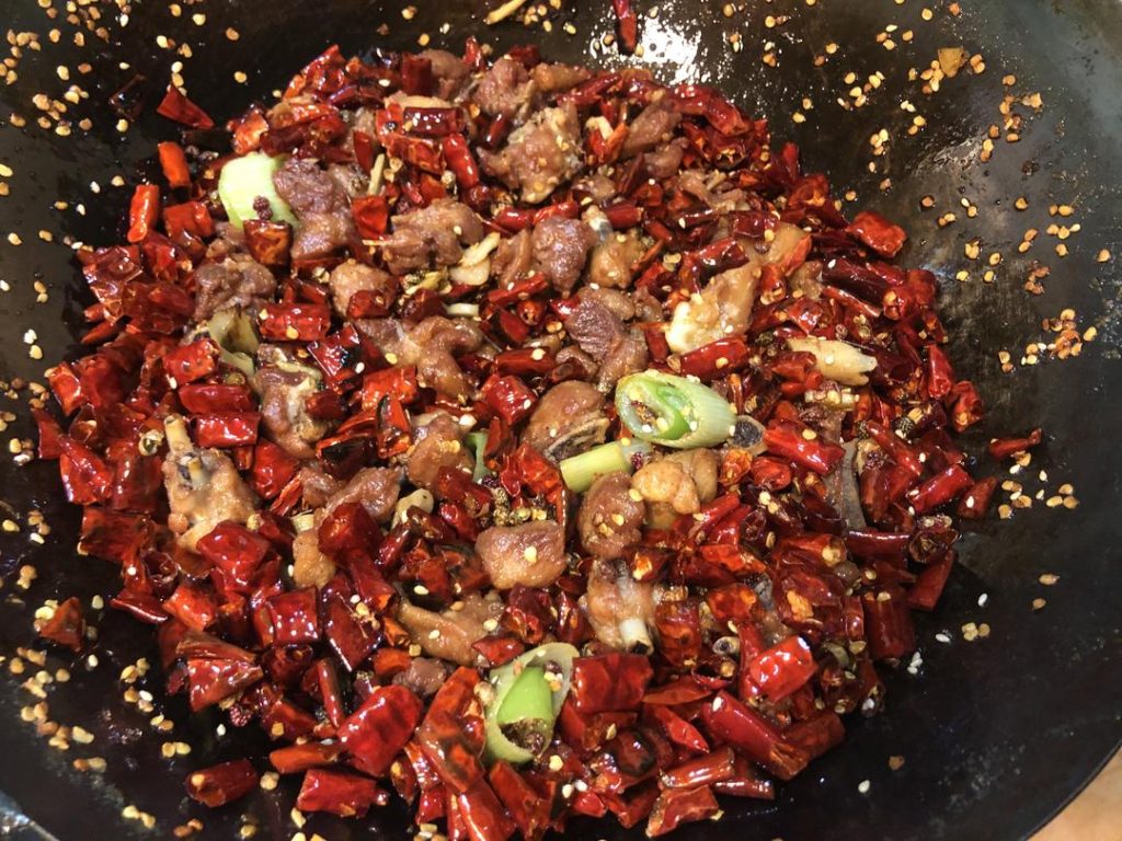 Dump the fried chicken back into the wok.