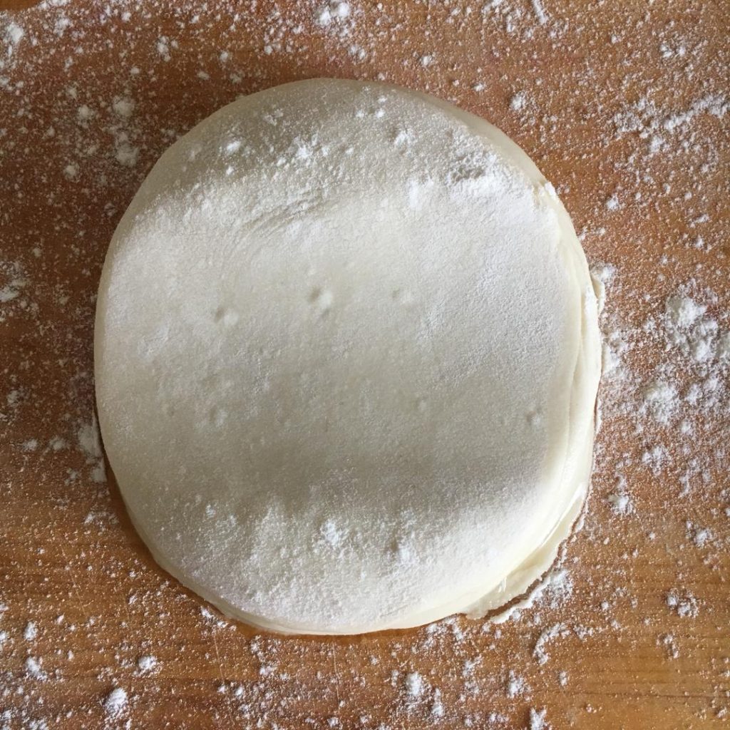 Take a rolling pin and gently press down on the stack of 10 discs.
