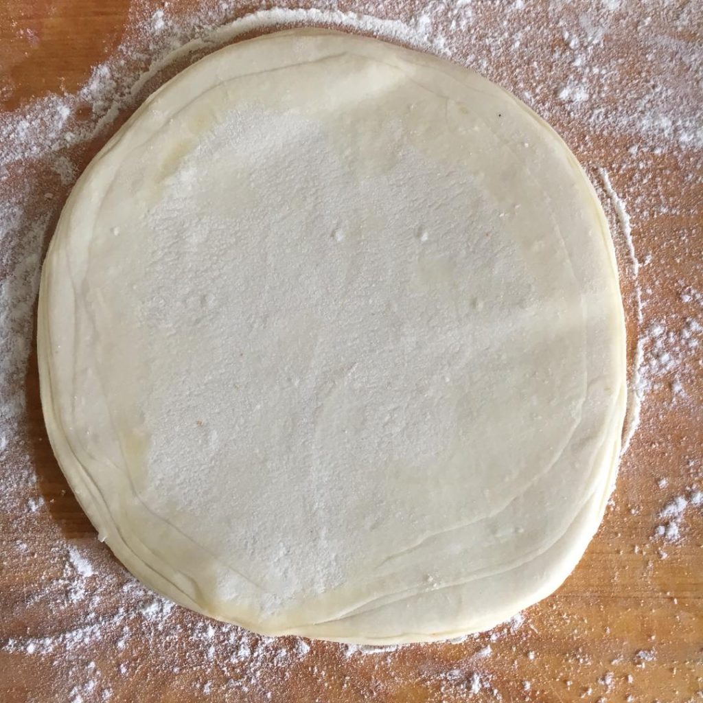 Take a rolling pin and gently press down on the stack of 10 discs.