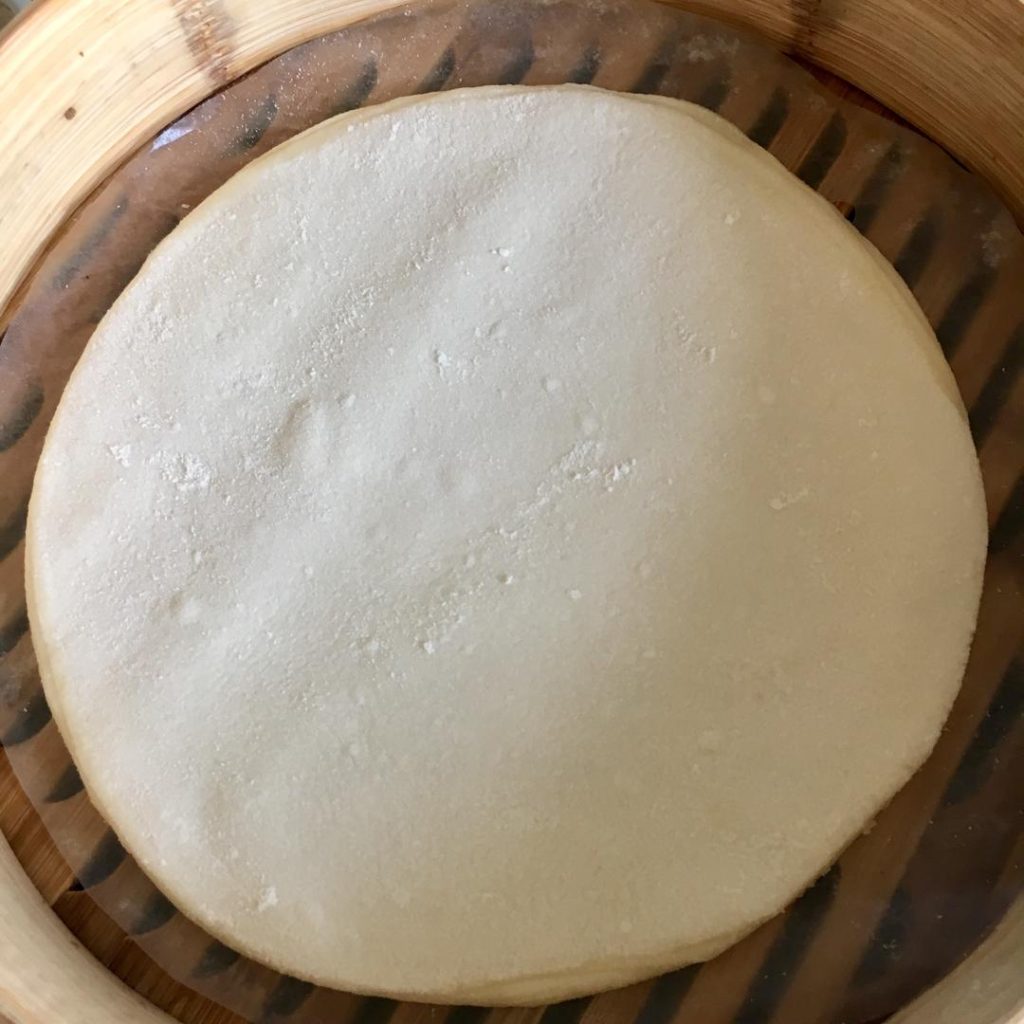 Take a rolling pin and gently press down on the stack of 10 discs.