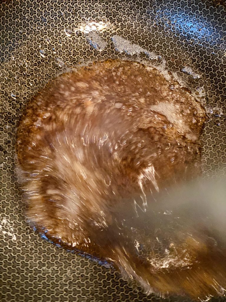 Pour the sauce into the hot wok.