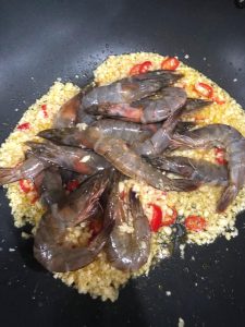 Add the marinated shrimp to the wok
