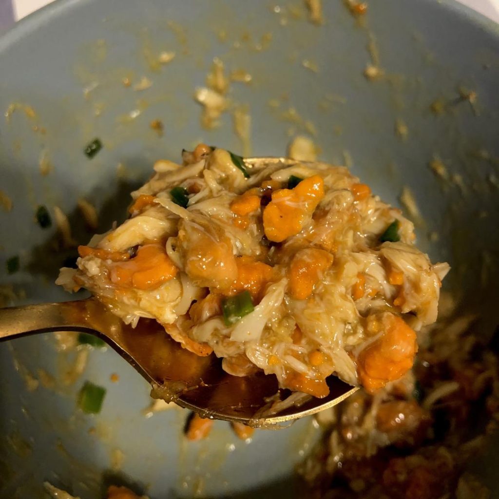 Ladle a generous amount of the hot crab roe sauce over the noodles