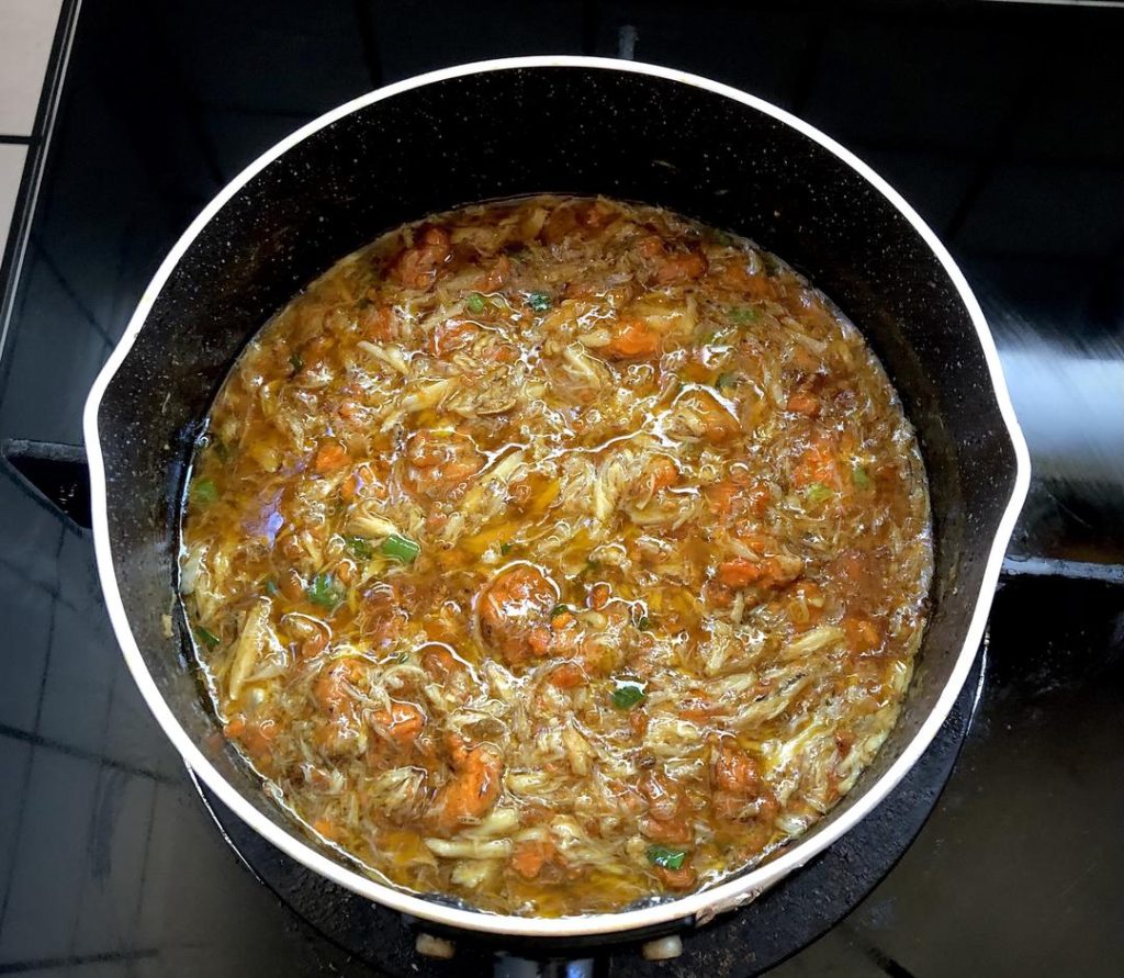 Ladle a generous amount of the hot crab roe sauce over the noodles