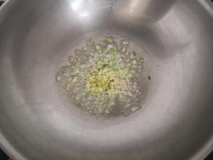 add the minced garlic, ginger, and the white parts of the green onion.