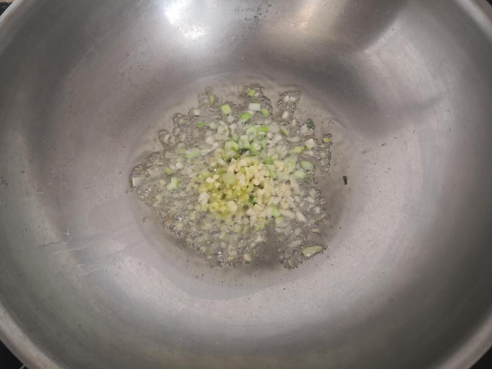 add the minced garlic, ginger, and the white parts of the green onion.