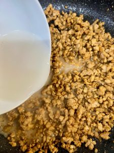 Give your cornstarch slurry a quick stir (the starch settles!) and pour it into the wok.