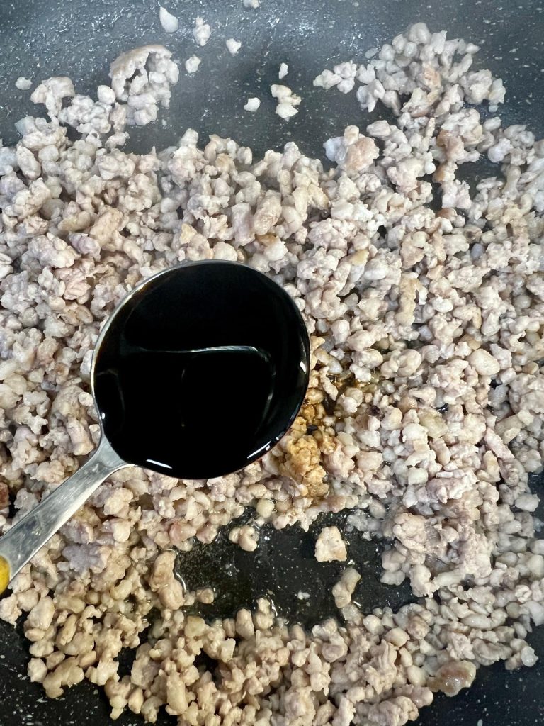 Add the 2 tablespoons of light soy sauce, 1 tablespoon of oyster sauce, and a small pinch of salt.