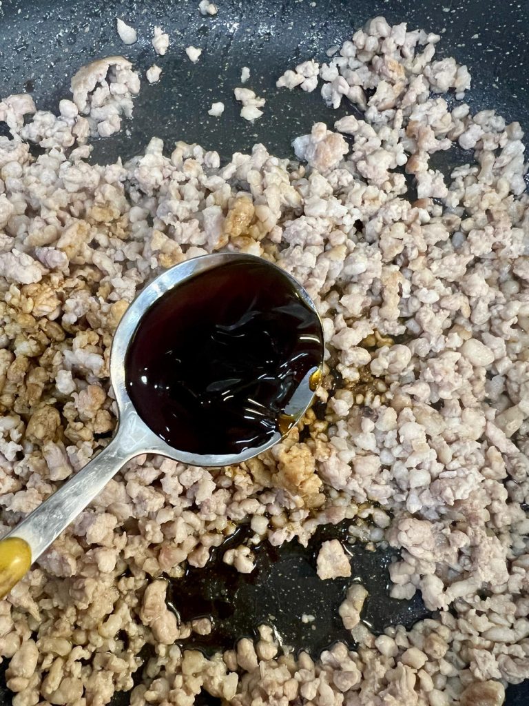 Add the 2 tablespoons of light soy sauce, 1 tablespoon of oyster sauce, and a small pinch of salt.