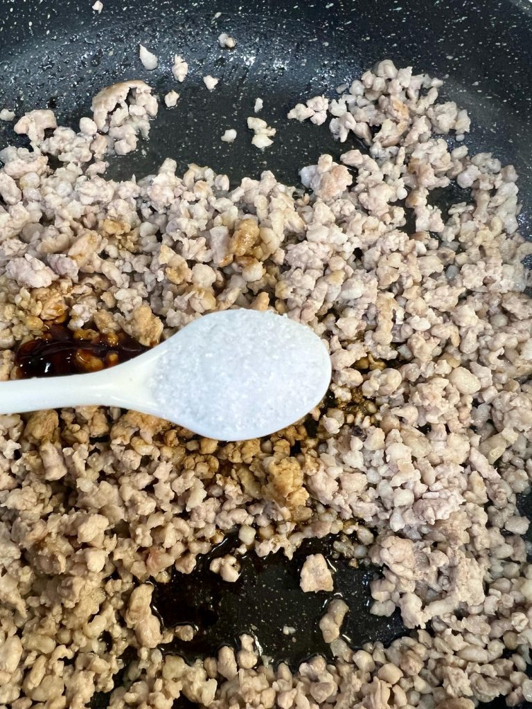 Add the 2 tablespoons of light soy sauce, 1 tablespoon of oyster sauce, and a small pinch of salt.