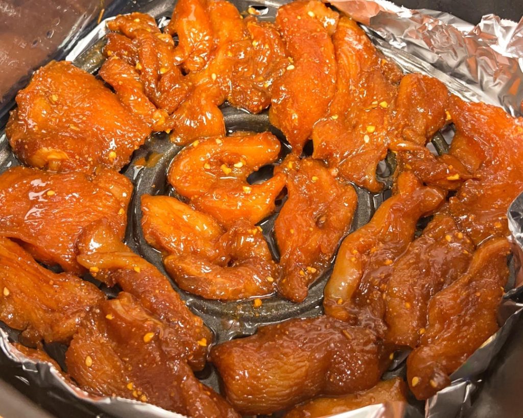First Bake: Preheat air fryer to 355°F (180°C). Brush basket with oil. Lay chicken cubes in a single layer. Cook for 15 minutes.