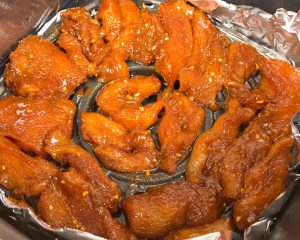 First Bake: Preheat air fryer to 355°F (180°C). Brush basket with oil. Lay chicken cubes in a single layer. Cook for 15 minutes.