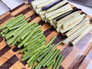 Eggplant: Cut into finger-length strips And Wash and cut into sections similar in length to the eggplant (about 2-3 inches).