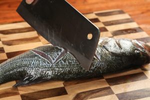 Score the Fish Pat the fish completely dry with paper towels.Using a sharp knife, score the fish on both sides. Instead of simple slashes, try a "Z" shape or "Zig-Zag" pattern.