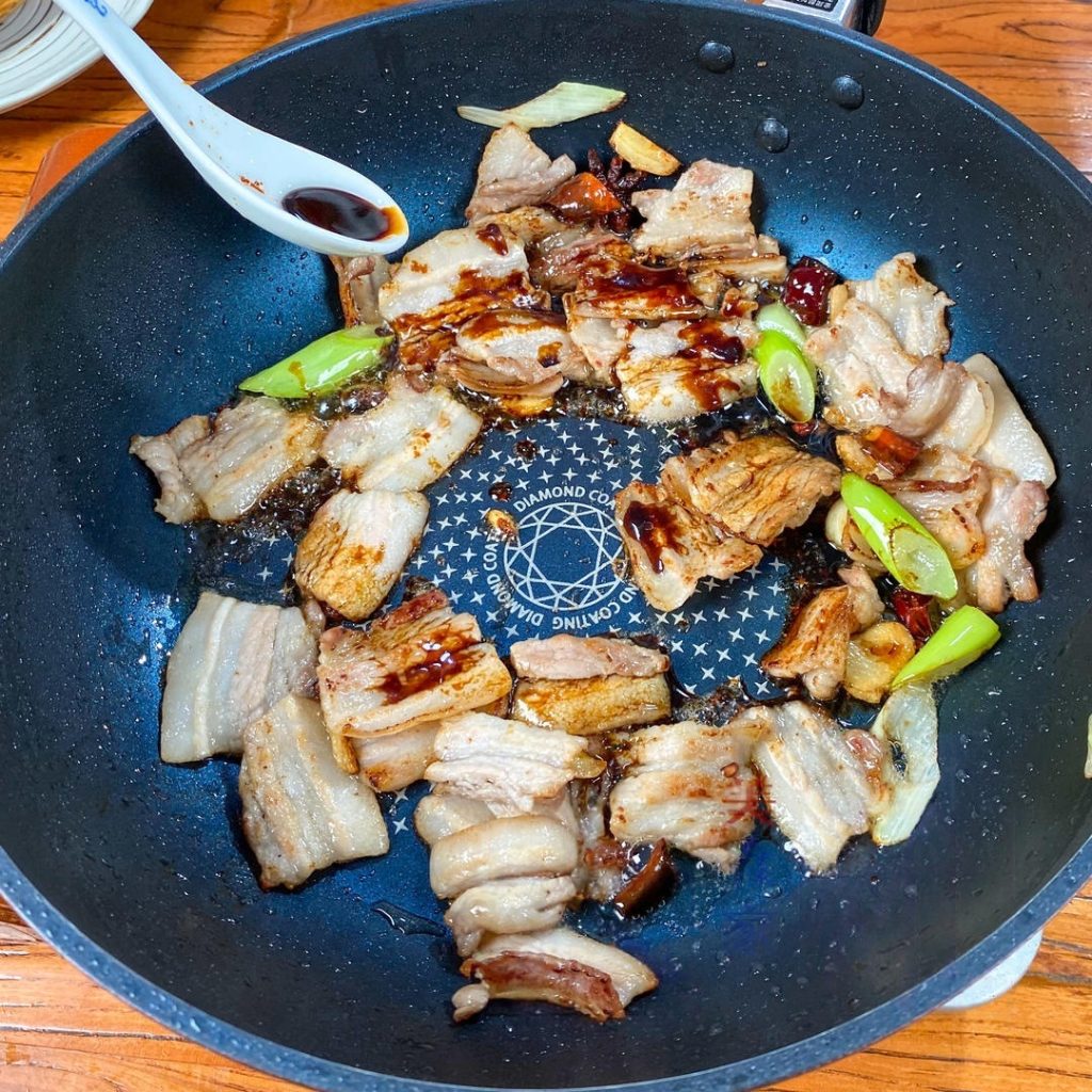 Add the separate 2 tablespoons of dark soy sauce directly to the pork.