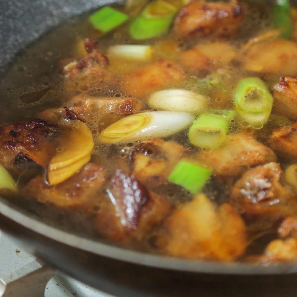 Pour in enough hot water to just barely cover the ribs.