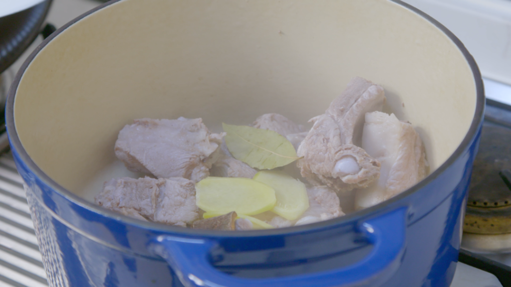 Place the clean ribs, ginger, star anise, cinnamon, and bay leaf into your pot. Pour the mixed sauce over the ribs.