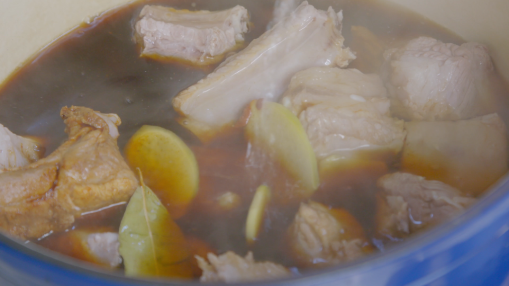 Place the clean ribs, ginger, star anise, cinnamon, and bay leaf into your pot. Pour the mixed sauce over the ribs.