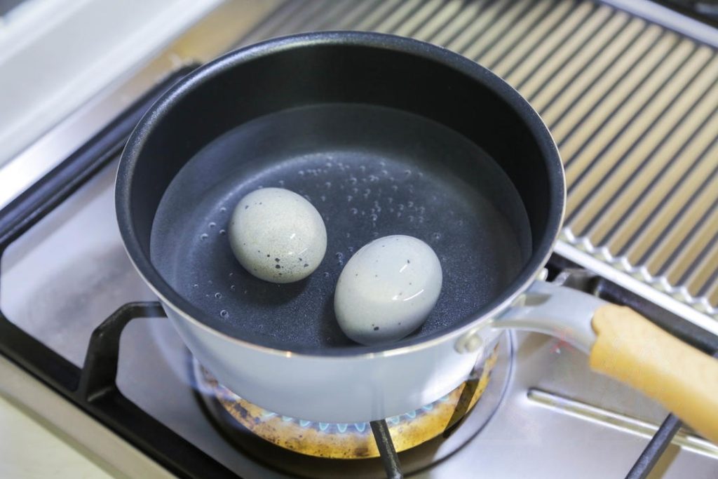Boil the Eggs: Place the century eggs (shell on) in a pot of cold water. Bring to a boil and cook for 5 minutes. This firms up the yolk. Peel and chop into chunks.