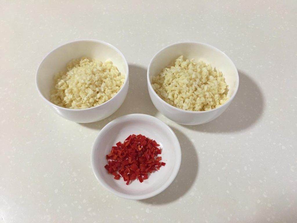 Separate the minced garlic into two bowls