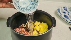 Pour this sauce evenly over the vegetables and meat. Then, pour in the water.