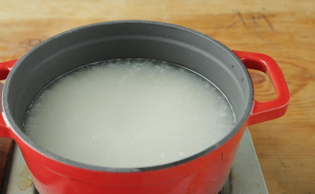 As the water approaches a boil, use a spatula to gently stir the rice from the bottom.