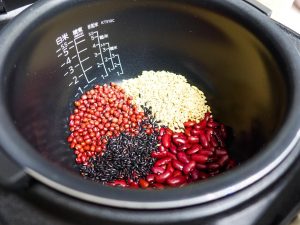 Drain the soaked red beans and kidney beans. Rinse the black rice and oats. Place all these solid ingredients into your cooking vessel of choice (Rice Cooker, Electric Pressure Cooker, or Pot).