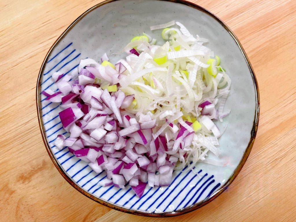 Finely dice the onion and scallion whites.