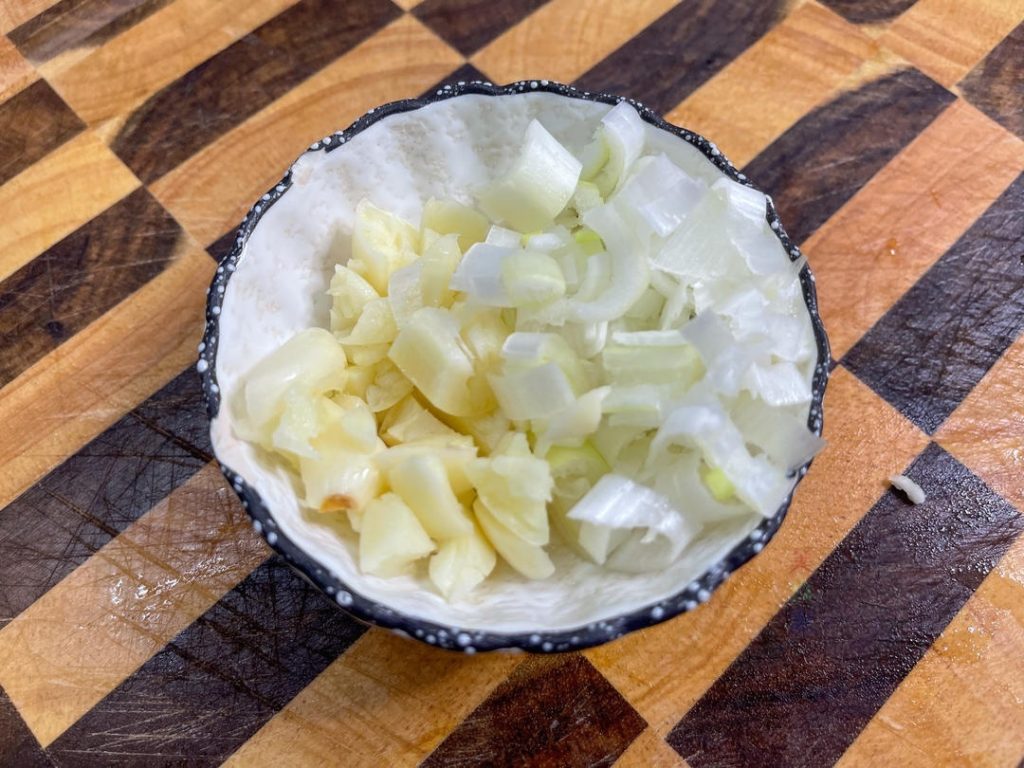 Finely chop the scallion (white part) and mince the 4 cloves of garlic.