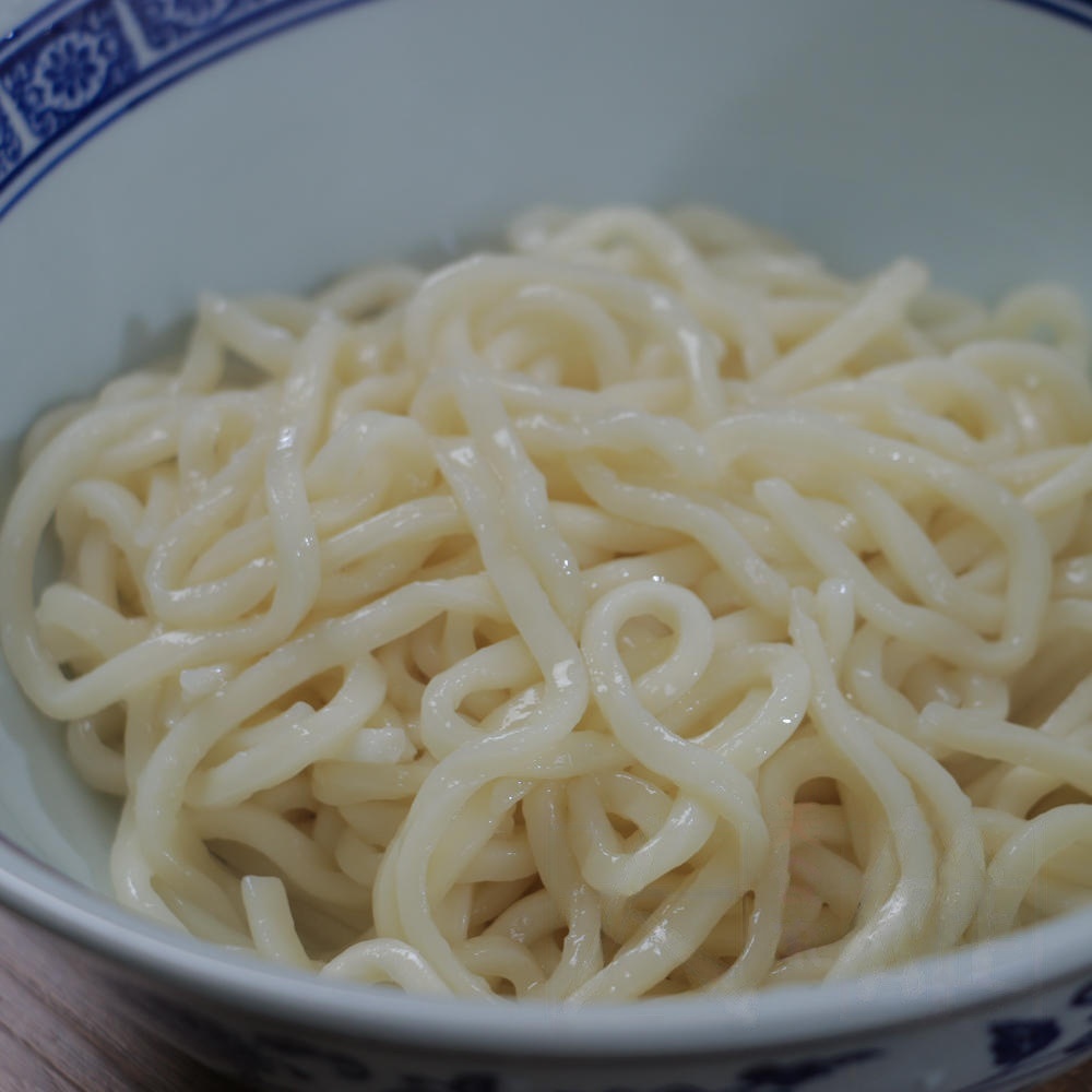Drain the noodles and transfer them to serving bowls.