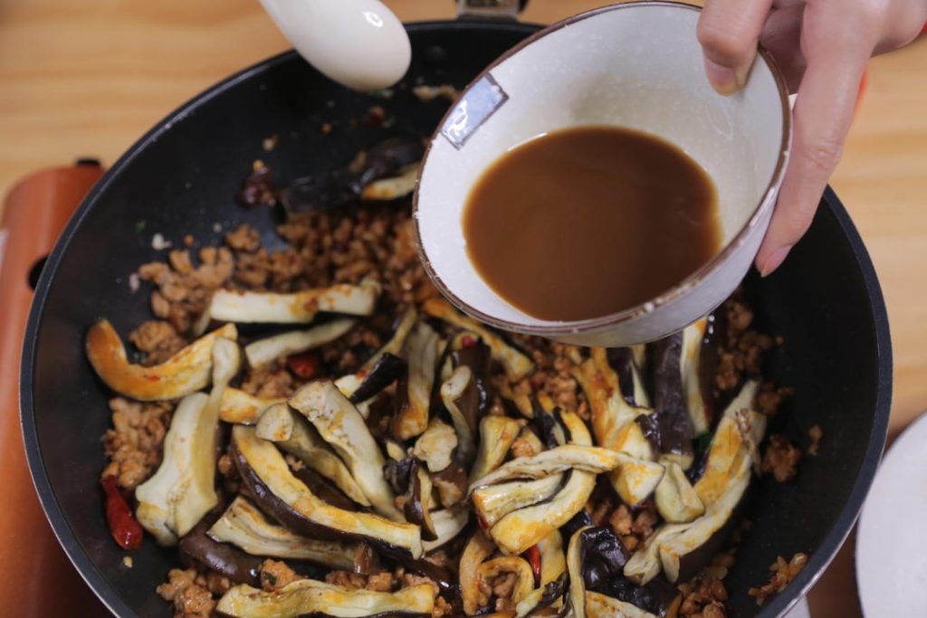 Give your sauce mixture a quick stir (cornstarch settles at the bottom) and pour it into the pan.