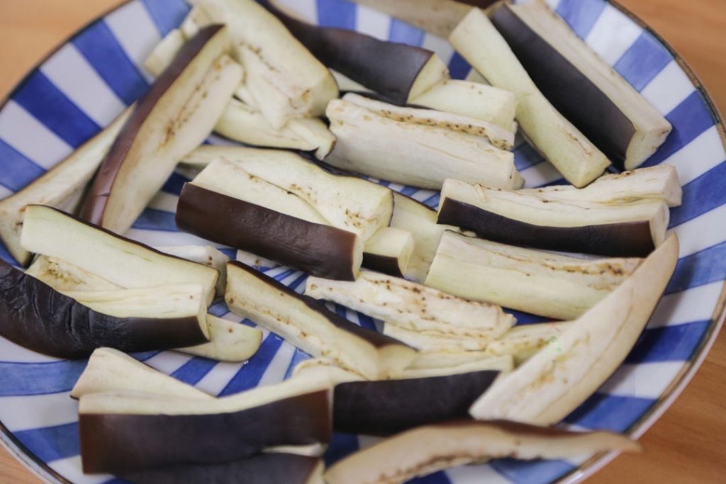 Spread the cut eggplant strips flat on a microwave-safe plate. Microwave on High for 8 minutes.