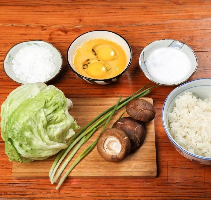 Dice the shiitake mushrooms into small cubes. Slice the iceberg lettuce into thin shreds. Chop the scallions into rings. Crack the two eggs into a bowl and beat them well until the yolk and white are fully combined.