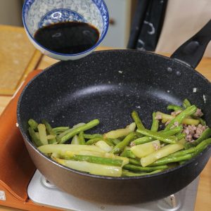 Add the cooked potatoes and green beans back into the pan with the pork.