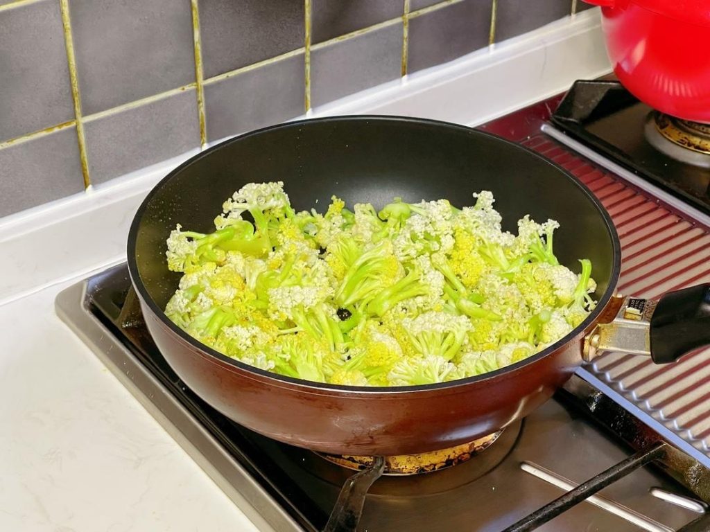 Add the cauliflower and a pinch of salt. The salt helps draw out moisture.