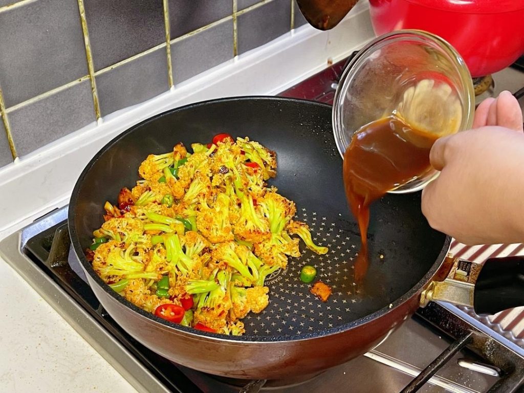 Push the ingredients to the side of the wok. Pour your prepared "mystery sauce" into the center/bottom of the hot wok.