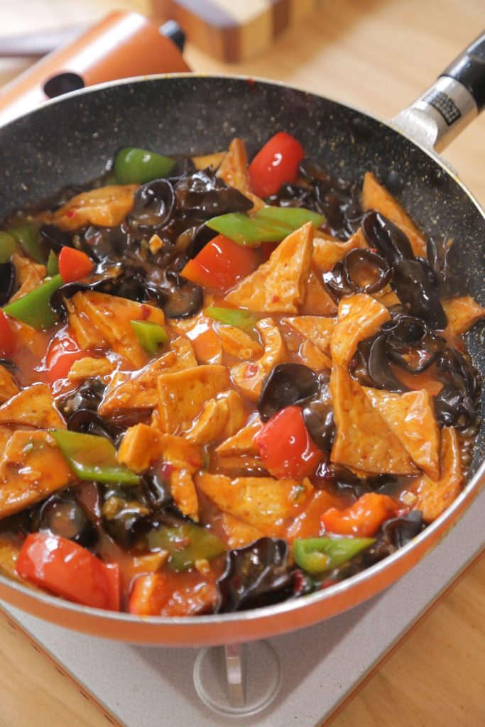Finally, give your cornstarch slurry a quick mix (starch settles!) and pour it into the sauce while stirring.