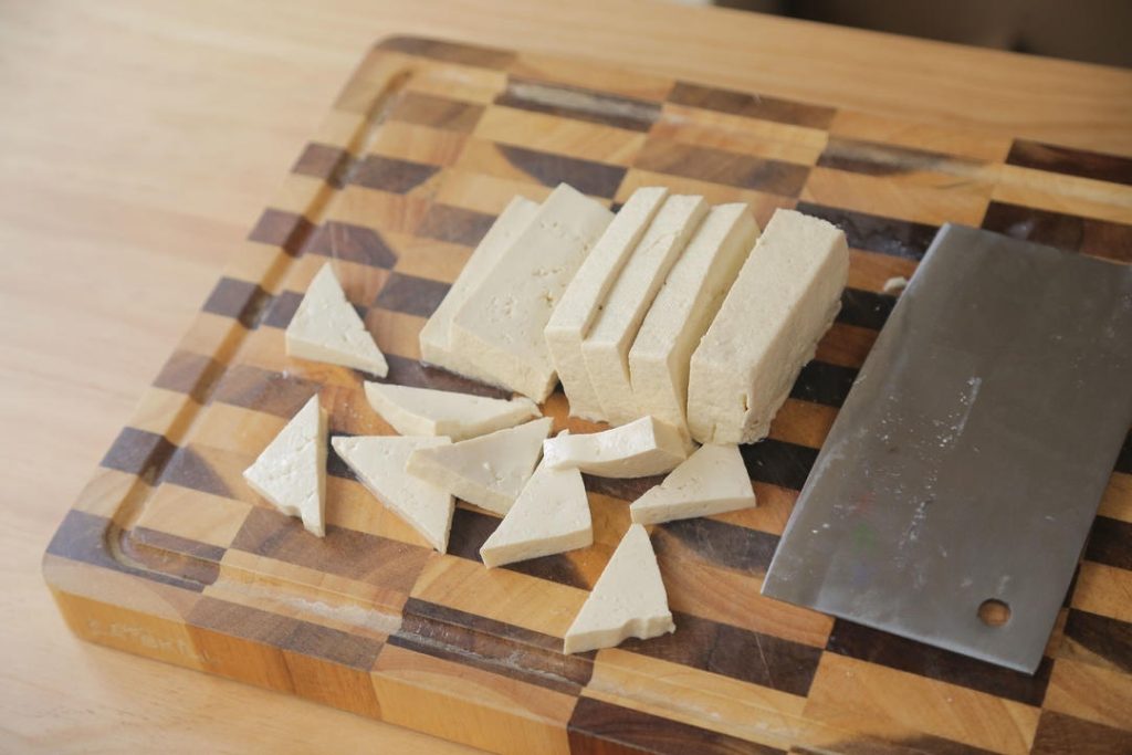 Cut the Tofu: Slice your block of firm tofu into triangles approximately 1cm (less than 1/2 inch) thick.