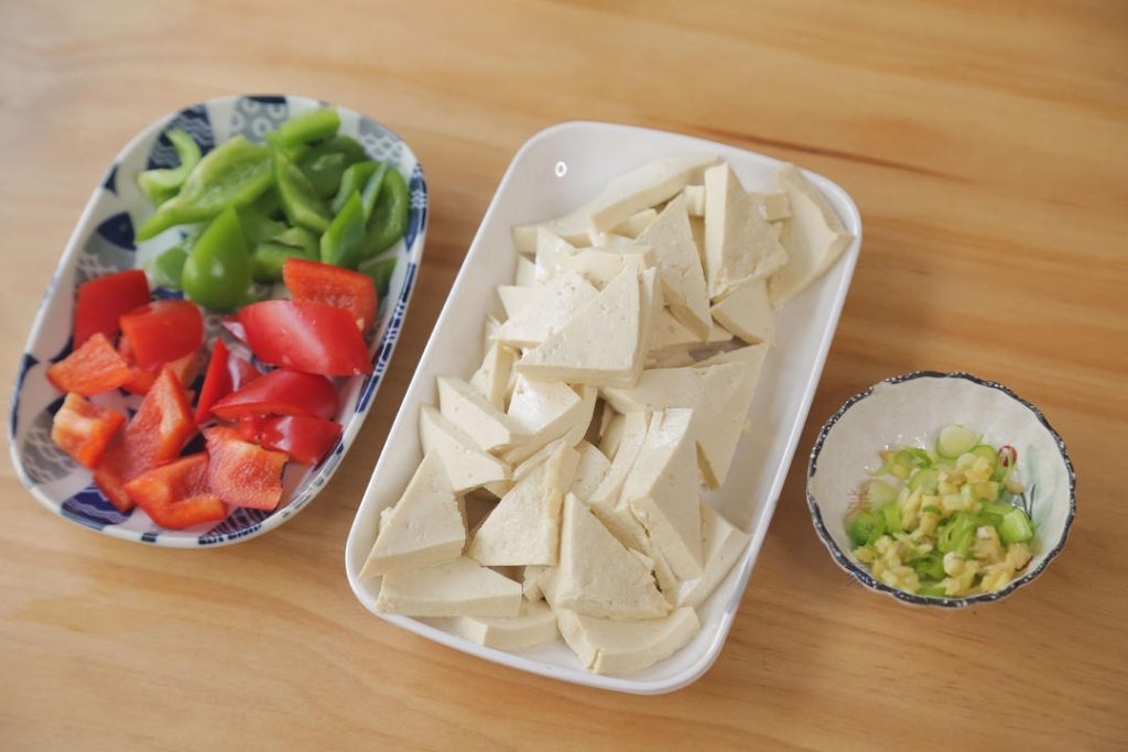 Prep Veggies: Tear the rehydrated wood ear mushrooms into bite-sized pieces. Cut the green and red peppers into diamond shapes or squares. Finely chop the scallions, ginger, and garlic.