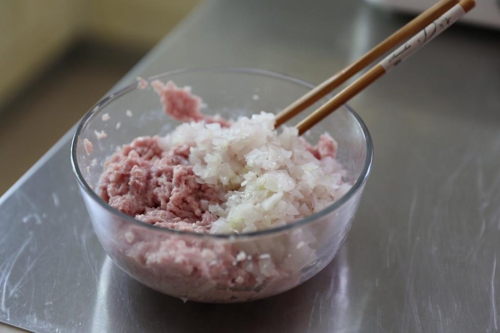 combine the ground pork and the cooled sautéed onions