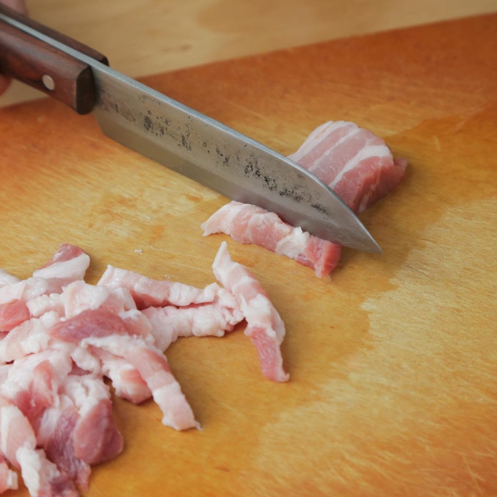 Slice the pork belly. Remove the rind (skin) if it is thick or tough.