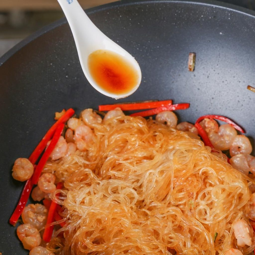 Pour 1 tbsp Shaoxing Wine around the perimeter of the pan.