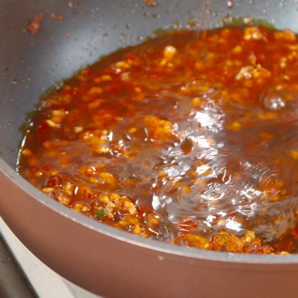 Pour the pre-mixed "Secret Sauce" into the pan with the meat. Bring it to a boil.