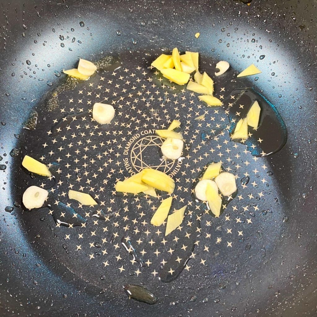 Add the ginger, garlic, and scallions. Stir-fry until fragrant (about 30 seconds).