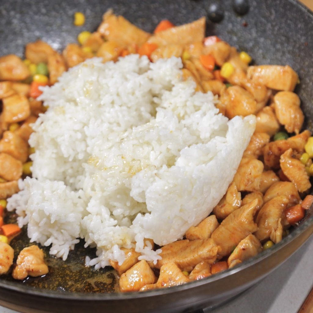 Add Rice and Stir-Fry Add the leftover rice to the pan. Use your spatula to break up any clumps, using a pressing and flipping motion.