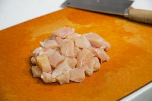 Cut the Chicken Cut the 2 chicken breasts into small cubes, approximately 3cm (1 inch) in size. Place them in a large mixing bowl.