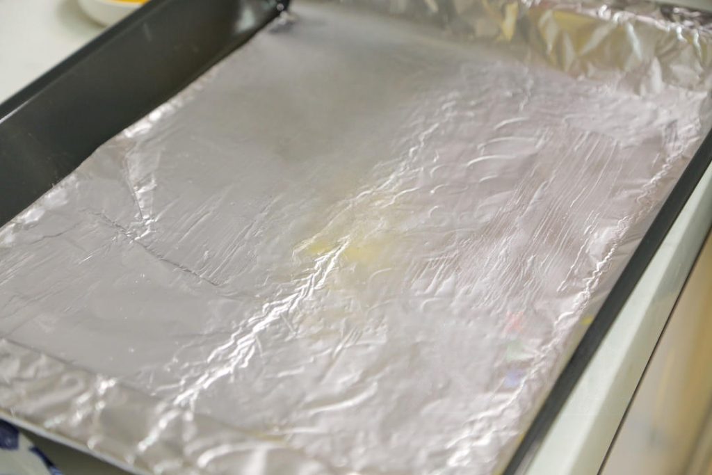 Prepare the Baking Sheet Line a baking sheet with aluminum foil or parchment paper.